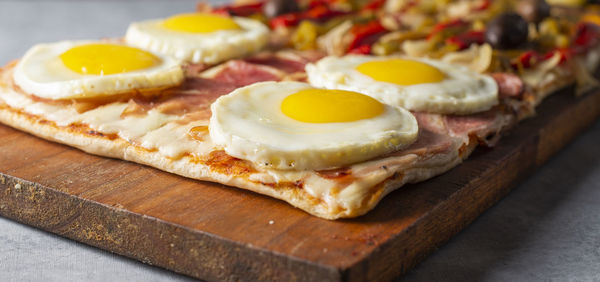 Close-up of pizza served on cutting board