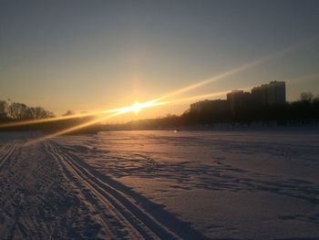 Scenic view of snow field against sky during sunset