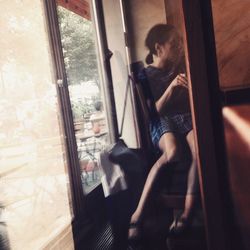 Woman looking through window