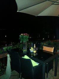 Close-up of table and chairs at night