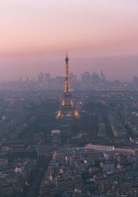 Aerial view of city lit up at sunset