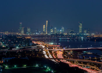 Illuminated cityscape against sky at night