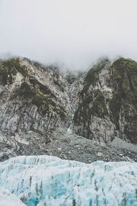 Scenic view of mountains and glaciers against sky during winter