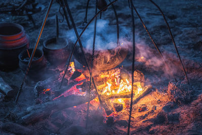 Low angle view of bonfire against orange sky