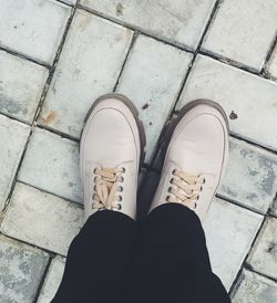 Low section of man standing on footpath