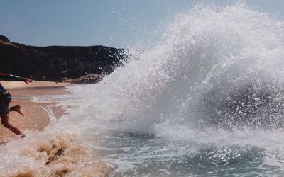 View of waves in sea against sky