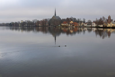 Reflection of buildings and trees in lake