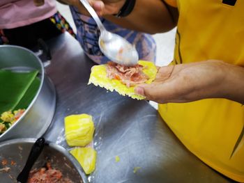 Midsection of person preparing food on table