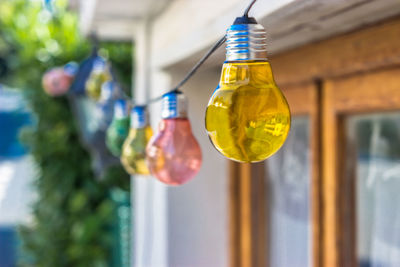 Light bulbs hanging outside house