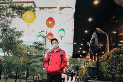 Full length of man standing on illuminated street light