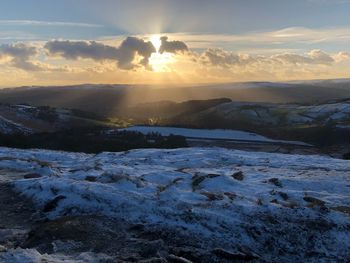 Scenic view of snow against sky during sunset