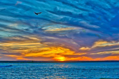 Scenic view of sea against sky at sunset