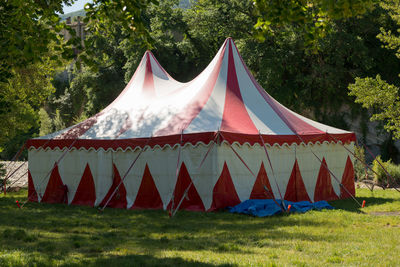 Tent on field against trees