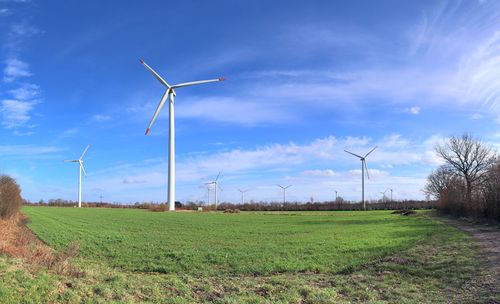 Windmill on field against sky