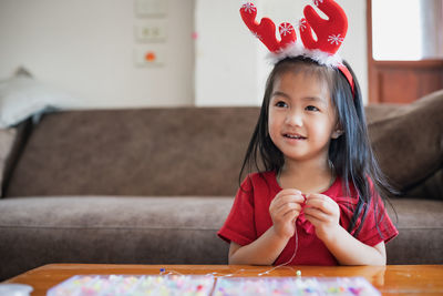 Cute girl doing craft at home