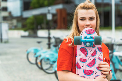 Portrait of cute girl playing with toy on road