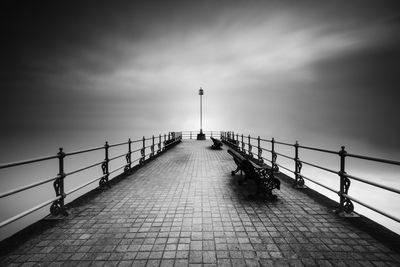 Bridge over sea against sky