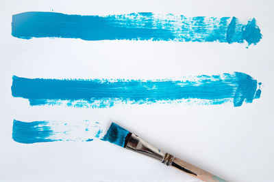 Close-up of blue paint against white background
