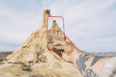 Cropped hand of woman using mobile phone