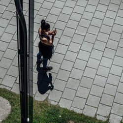 High angle view of woman on footpath