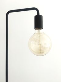 Close-up of light bulb against white background