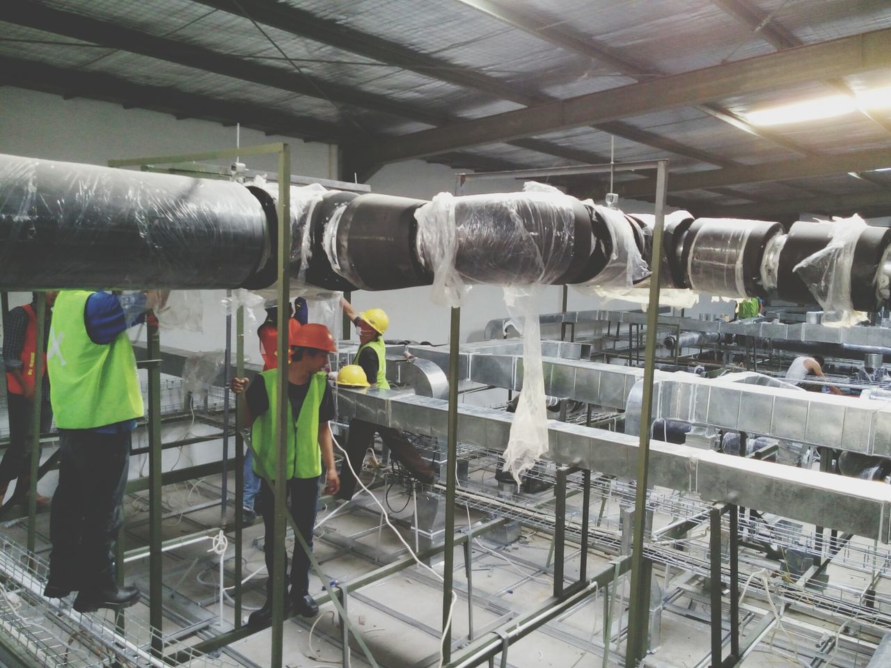 indoors, metal, large group of objects, in a row, factory, abundance, industry, arrangement, pipe - tube, metallic, order, variation, hanging, retail, equipment, transportation, no people, machinery, still life, choice