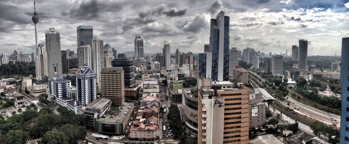 City skyline against cloudy sky