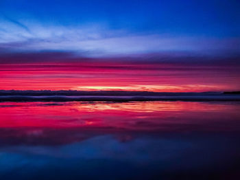 Scenic view of dramatic sky over sea during sunset
