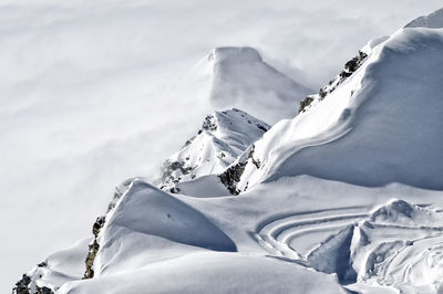 Low angle view of snowcapped mountain against sky