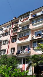 Low angle view of buildings against clear blue sky