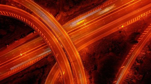 High angle view of light trails on highway at night