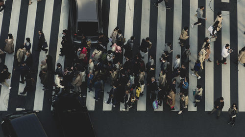 High angle view of people walking on street in city