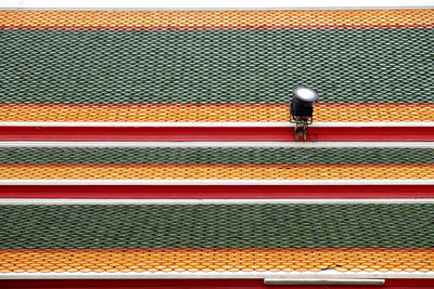 Low angle view of lighting equipment on colorful wall