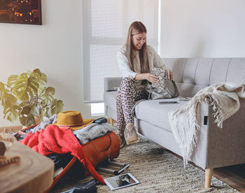 Portrait of woman sitting on bed at home