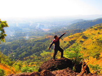 Rear view of man standing on mountain