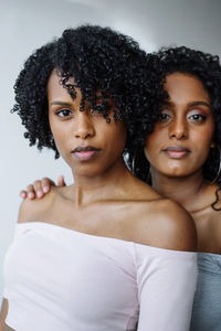 Portrait of two women of color hugging each other