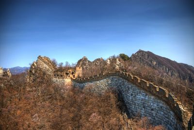 Scenic view of mountains against blue sky
