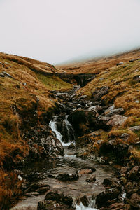 Scenic view of waterfall against clear sky