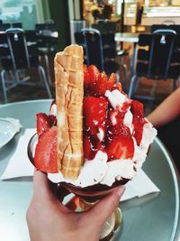 Midsection of person holding ice cream in plate