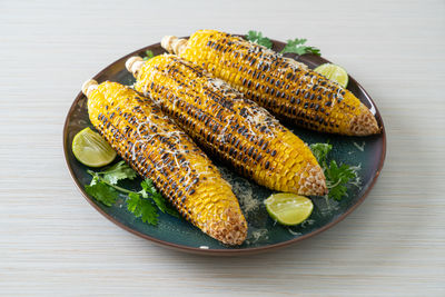 High angle view of corns in plate on table