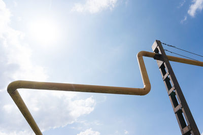 Low angle view of pipe against sky