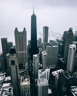 Aerial view of buildings in city during foggy weather