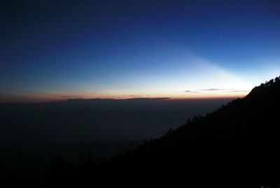 Scenic view of silhouette mountains against sky at sunset