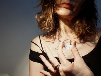 Close-up of young woman against gray background