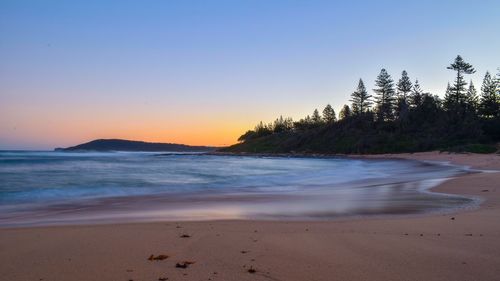 Scenic view of sea against clear sky during sunset