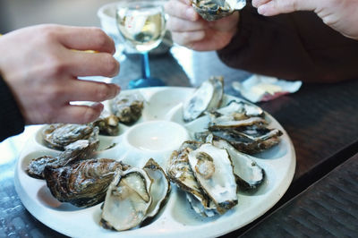 Close-up of people enjoying seafood at dinner