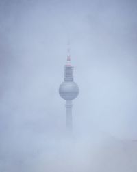 Close up of tv tower encased by fog