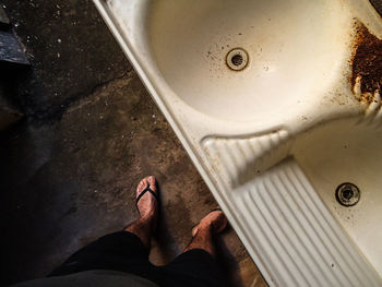 Low section of person standing on metal