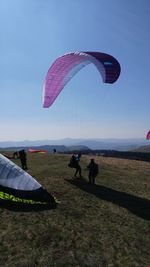 Man flying kite against sky