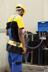 Rear view of man standing in factory